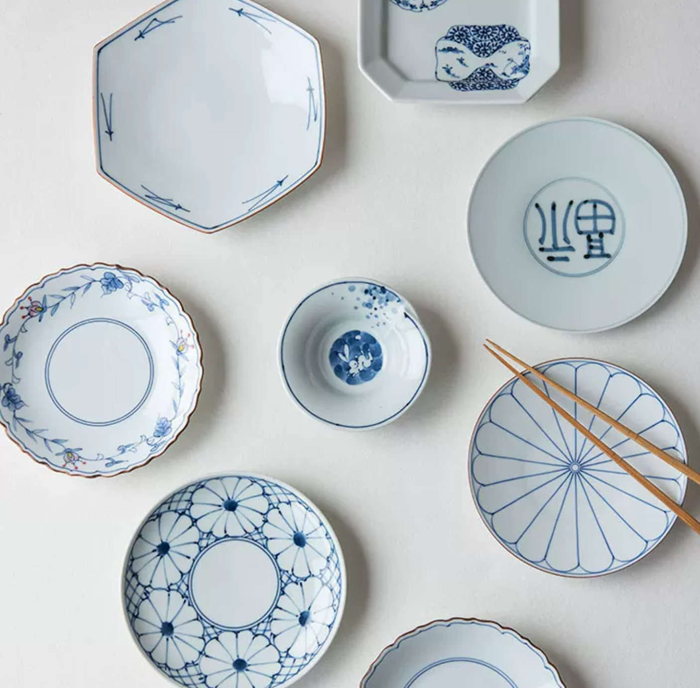 Japanese Imari blue and white porcelain tableware collection — Hasami auspicious pattern, flat lay with chopsticks