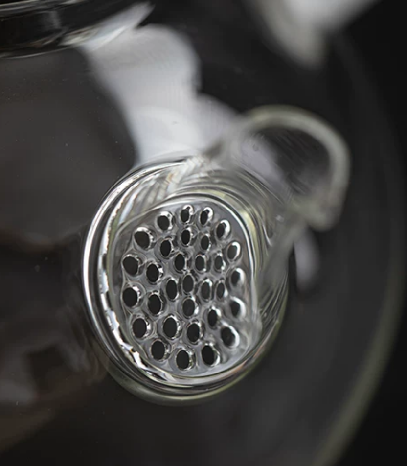 Glass kettle boiling water on walnut stove base
