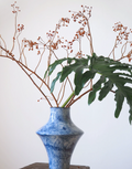 Blue cloud ceramic vase with palm leaf, close view