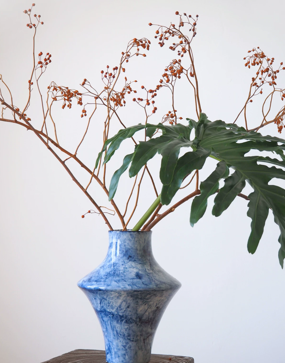 Blue cloud ceramic vase with palm leaf, close view
