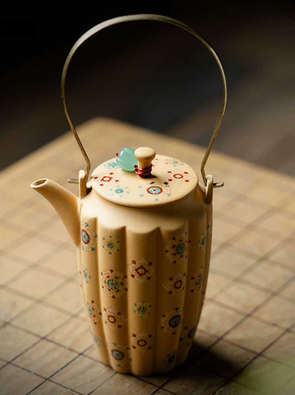 Handmade Zisha Teapot — black background, hand holding