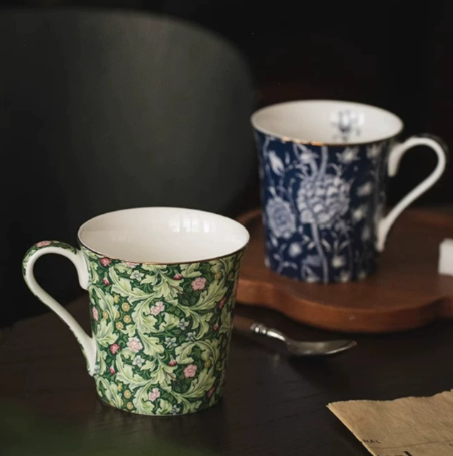 Forest Acanthus and navy floral mugs on dark wood table