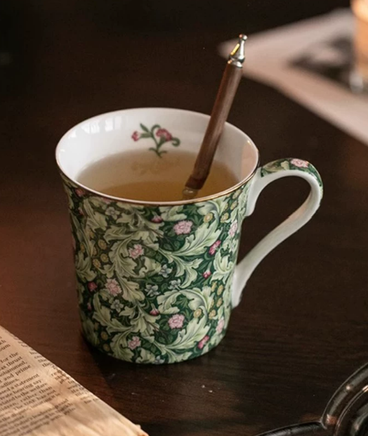 Forest Acanthus mug with tea and stirrer — lifestyle