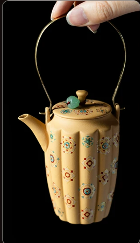 Handmade Zisha Teapot — held in hands, side view